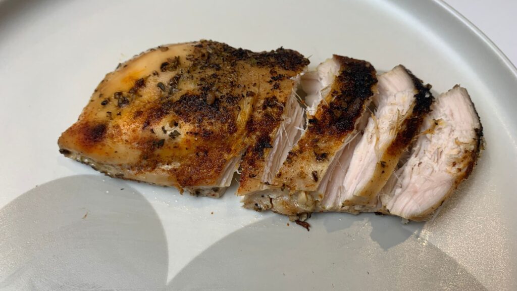 healthy slow cooker chicken breasts sliced on Mickey Mouse. plate