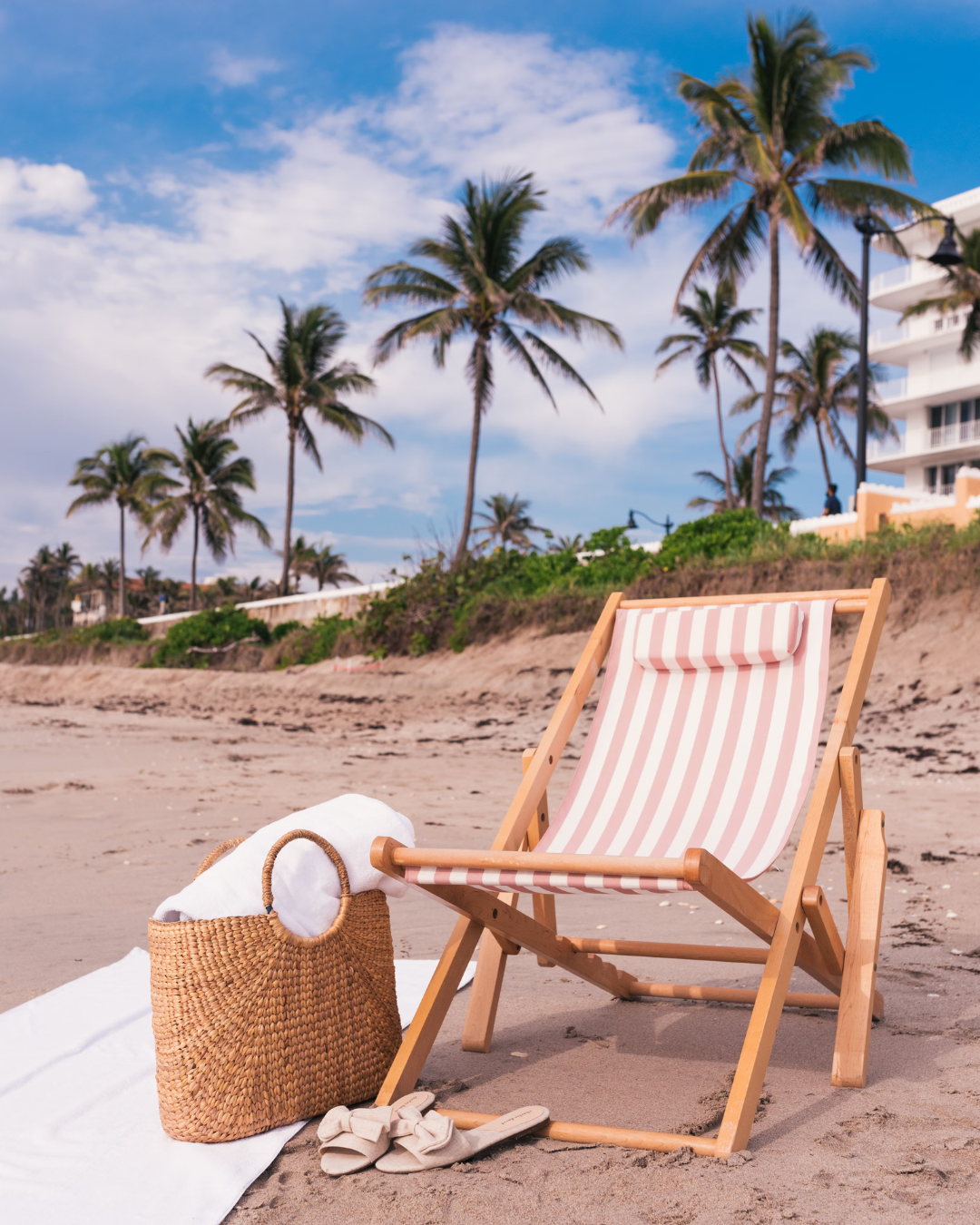 at the beach pink lawn chair purse towel and shoes
